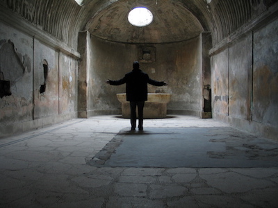 Mensch in segnender Haltung in einer alten Kapelle