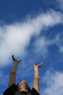 Hochgestreckte Arme zum blauen Himmel