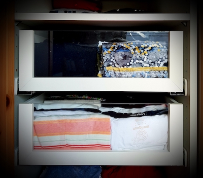 Geöffneter Kleiderschrank mit zwei Schubfächern