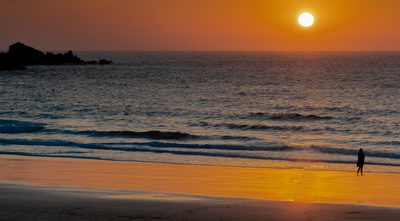 Frau am Meer beim Sonnenuntergang
