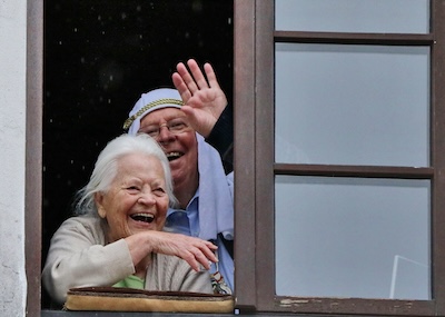 2 lachende Gesichter am Fenster beim Karnevalsumzug